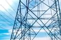 High voltage electric tower and transmission lines. Electricity pylons with blue sky and white clouds. Power and energy Royalty Free Stock Photo