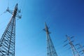 high voltage electric towers under blue sky