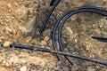 The high voltage electrical cable is laid in a trench under existing engineering sewerage networks. Laying a high voltage cable Royalty Free Stock Photo