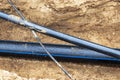The high voltage electrical cable is laid in a trench under existing engineering sewerage networks. Laying a high voltage cable Royalty Free Stock Photo