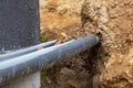 The high voltage electrical cable is laid in a trench under existing engineering sewerage networks. Laying a high voltage cable Royalty Free Stock Photo