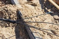 The high voltage electrical cable is laid in a trench under existing engineering sewerage networks. Laying a high voltage cable Royalty Free Stock Photo