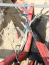 high voltage electrical cables inside the excavation of a road construction site for the repair of the power line