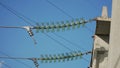 High-voltage electrical insulator of the electric line on a background of blue sky. Portal of the high voltage line Royalty Free Stock Photo