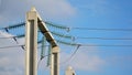 High-voltage electrical insulator of the electric line on a background of blue sky. Portal of the high voltage line. Royalty Free Stock Photo