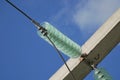 High-voltage electrical insulator of the electric line on a background of blue sky. Portal of the high voltage line. Royalty Free Stock Photo