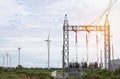 high voltage electrical power pylon substation with wind turbines renewable wind energy Royalty Free Stock Photo