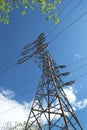 High voltage electrical pylon. Low angle shot against a blue sky. Royalty Free Stock Photo