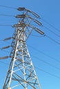 High voltage electrical pylon. Low angle shot against a blue sky. Royalty Free Stock Photo