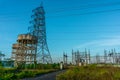 High voltage Electrical substation with steel frames, insulators and electricity transmission power lines and blue sky background Royalty Free Stock Photo