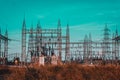 High voltage Electrical substation with steel frames, insulators and electricity transmission power lines and blue sky background Royalty Free Stock Photo