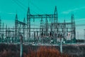 High voltage Electrical substation with steel frames, insulators and electricity transmission power lines and blue sky background Royalty Free Stock Photo