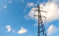 High voltage electrical support. Clear blue sky with cumulus clouds in the background. The energy industry. The current goes Royalty Free Stock Photo