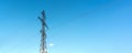 High voltage electrical support. Clear blue sky with cumulus clouds in the background. The energy industry. The current goes Royalty Free Stock Photo