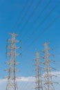 High voltage electrical tower blue sky background. Royalty Free Stock Photo