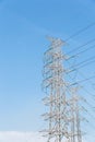 High voltage electrical tower blue sky background. Royalty Free Stock Photo