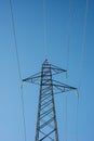 High voltage electricity cables over a blue sky Royalty Free Stock Photo
