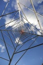 High Voltage Electricity Grid Pylon seen from below with blue sky and clouds Royalty Free Stock Photo