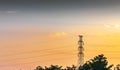 High voltage electricity post in countryside with mountain and sunset sky background Royalty Free Stock Photo