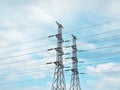 High Voltage Electricity Power Transmission Towers Against Blue Cloudy Sky Royalty Free Stock Photo