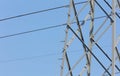 High-voltage electricity pylon against blue sky with lightning rod Royalty Free Stock Photo