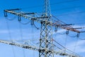 high-voltage electricity pylons against blue sky Royalty Free Stock Photo