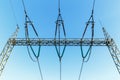 high-voltage electricity pylons against blue sky Royalty Free Stock Photo