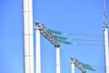 High voltage electricity pylons against perfect blue sky with white clouds. electric poles Royalty Free Stock Photo