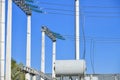 High voltage electricity pylons against perfect blue sky with white clouds. electric poles Royalty Free Stock Photo