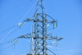 High voltage electricity pylons against perfect blue sky with white clouds. electric poles Royalty Free Stock Photo