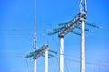 High voltage electricity pylons against perfect blue sky with white clouds. electric poles Royalty Free Stock Photo