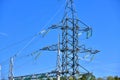 High voltage electricity pylons against perfect blue sky with white clouds. electric poles Royalty Free Stock Photo