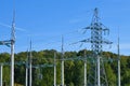 High voltage electricity pylons against perfect blue sky with white clouds. electric poles Royalty Free Stock Photo