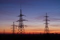 High voltage electricity pylons, sunset. Royalty Free Stock Photo