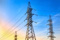 High voltage electricity pylons and transmission power lines on the blue sky background. Royalty Free Stock Photo