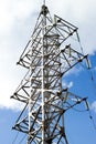 High voltage electricity pylons and transmission power lines on the blue sky and clouds background. Vertical Royalty Free Stock Photo