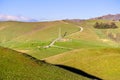 High voltage electricity tower and ranch barn surrounded by green hills and valleys in the Diablo Range Mountains in South San Royalty Free Stock Photo