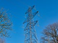 A high voltage electricity transmission pylon in winter - part of the national grid for the distribution of power Royalty Free Stock Photo