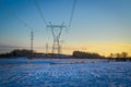 High voltage electricity transmission towers by aerial cables in winter Royalty Free Stock Photo