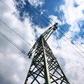 High voltage eletrical towers and lines with blue sky and clouds. Eletricity towers with blue sky background. Royalty Free Stock Photo