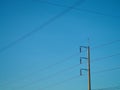 The high voltage light pole fastened to multiple wires leading to On the background is a blue sky.