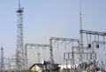 High-voltage lines against the background of electrical distribution stations at sunrise. Royalty Free Stock Photo