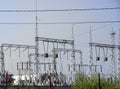 High-voltage lines against the background of electrical distribution stations at sunrise.