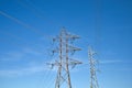 High voltage lines and power pylons against blue sky Royalty Free Stock Photo