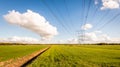 High voltage lines and power pylons in a Dutch agricultural land Royalty Free Stock Photo