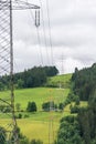 High voltage overhead power line, power pylon, steel lattice tower standing in the mountains landscape. Royalty Free Stock Photo