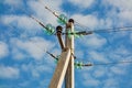 High-voltage Overhead power line with wires and insulators on a concrete pole close-up on a sunny day against a background Royalty Free Stock Photo