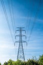 High voltage pole with blue sky background, Electric transmission line system for large industrial plants. Royalty Free Stock Photo