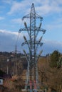 High voltage pole. The column stands in the middle of the gardens. The blue sky is in the background