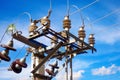 High-voltage pole with insulators and wires against blue sky. Electric pole with close-up equipment. Royalty Free Stock Photo